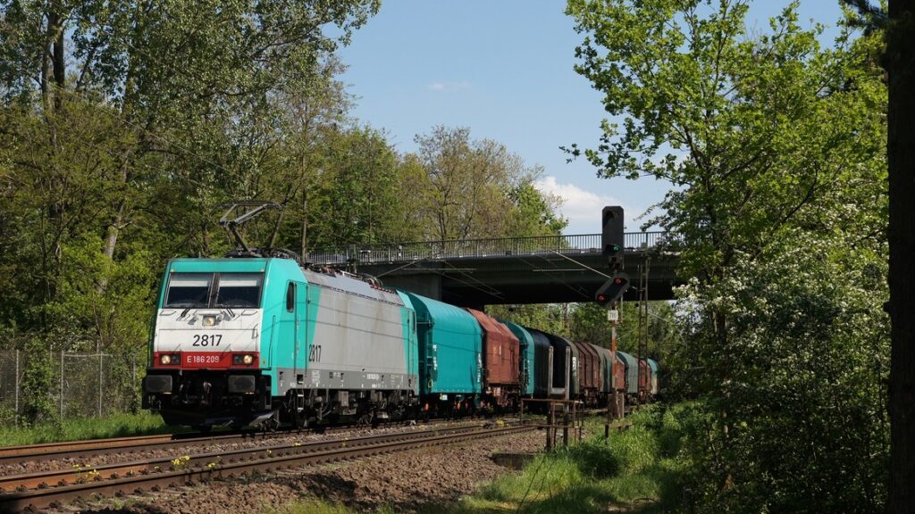 An Alpha Trains' Traxx locomotive in service on a European rail freight corridor
