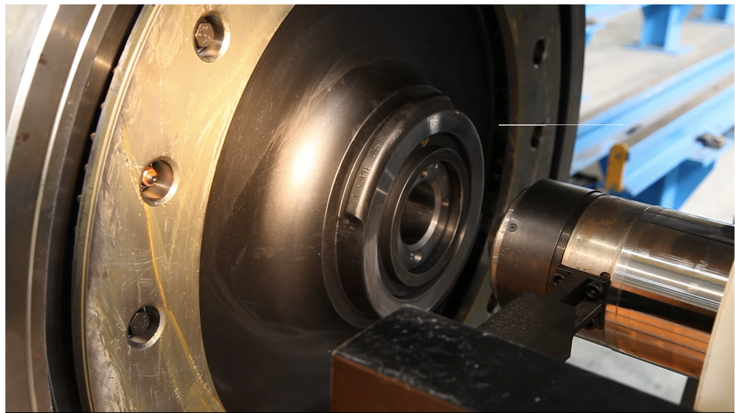 Close-up of wheel and press cylinder with centring tool