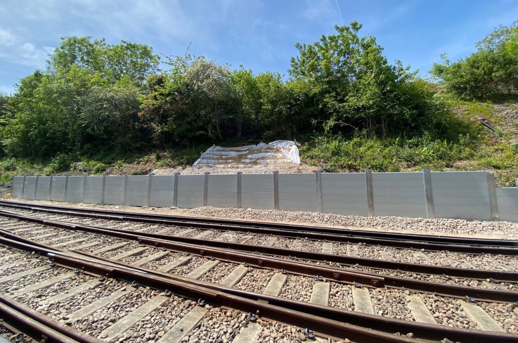 Cropped ballast boards at the side of a railway track