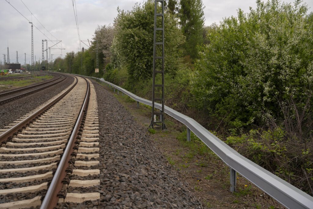 The arcosystem troughing to the side of the tracks