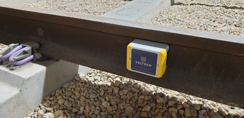 An image of Yeltech's rail temperature monitoring unit affixed to a track