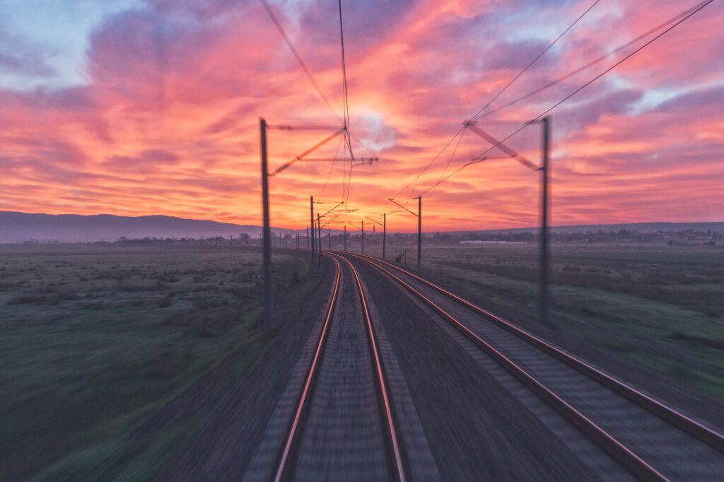 An image showing a railway track at sunset