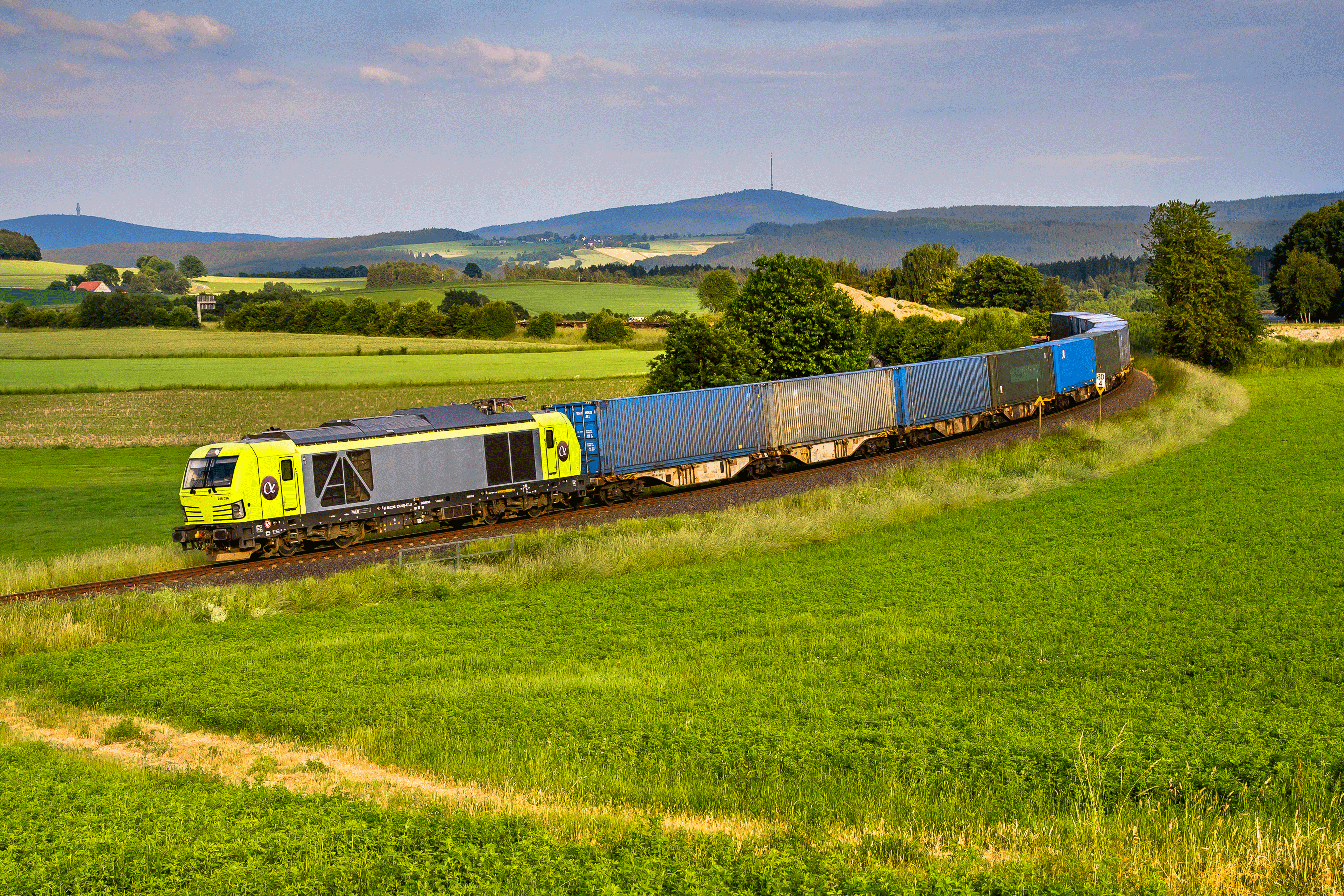 A Siemens Vectron locomotive owned by Alpha Trains hauling freight