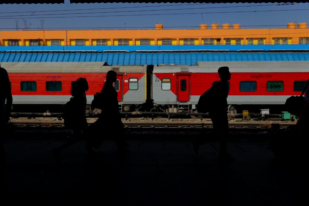 An image of passengers walking past a waiting train