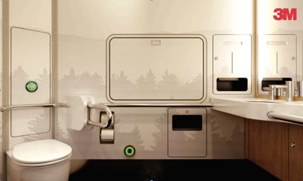 A train toilet with forest graphics on the walls