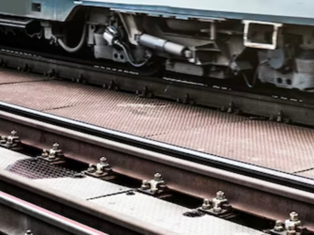 An image of railway tracks alongside an obscured carriage