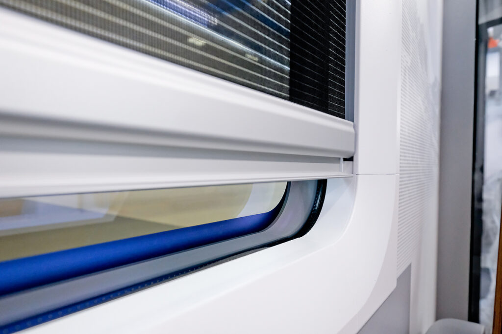 Cable-guided roller blinds on a train window
