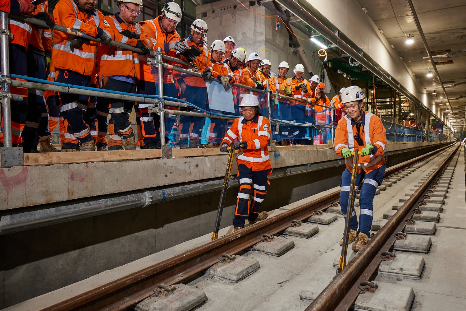 In the tunnel near Te Waihorotiu Station in central Auckland, two of the track laying team, Alexandra Favre, a Link Alliance track engineer, and Amy Khune, a Martinus surveyor, locked into place the last of more than 21,000 rail clips