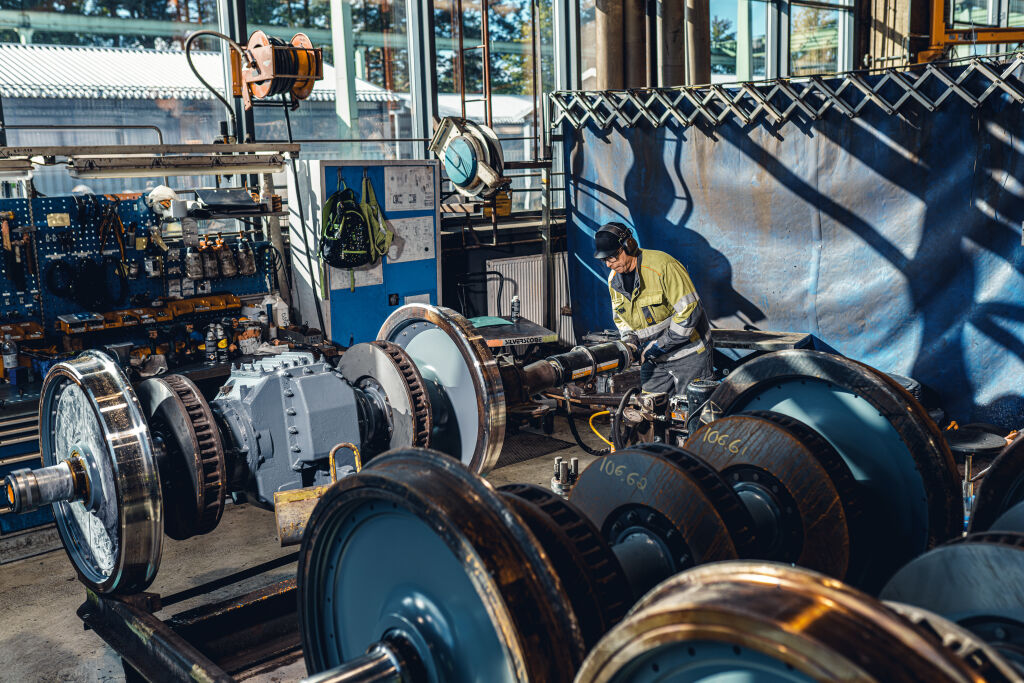 A worker in high-vis doing wheelset maintenance