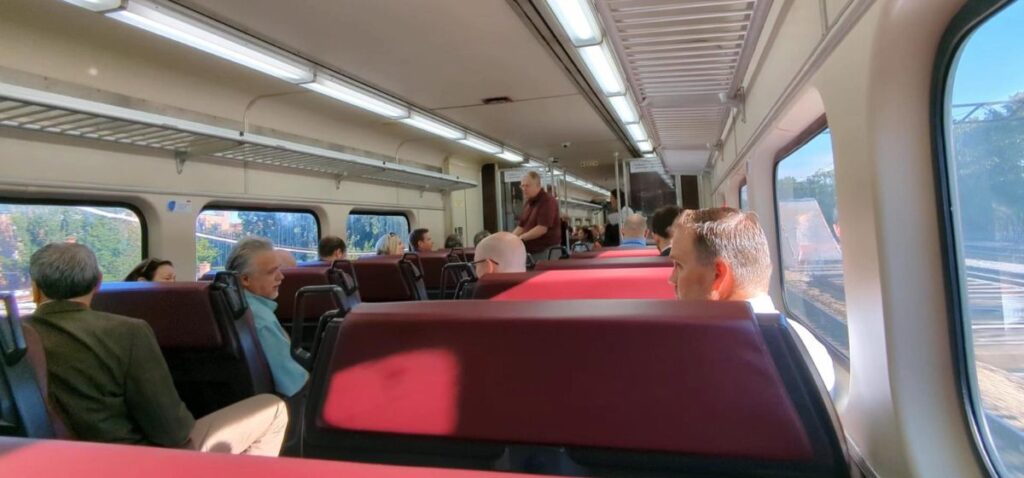 The interior of a train with red seating
