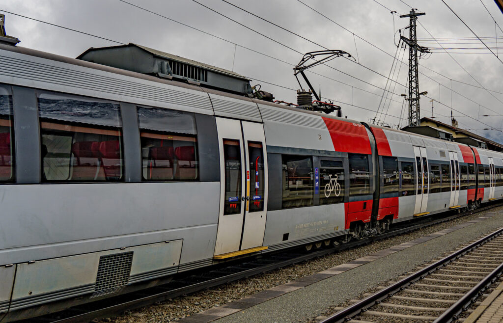 A grey and red tram train