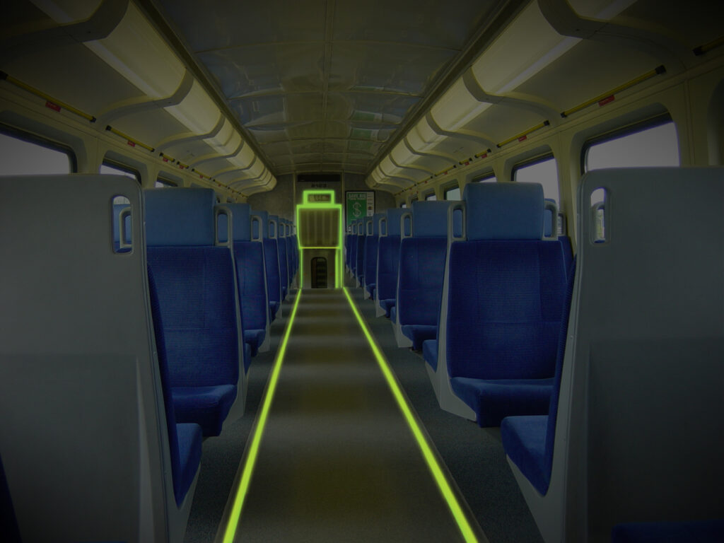 Neon tape highlighting the train aisle and emergency exit in the dark