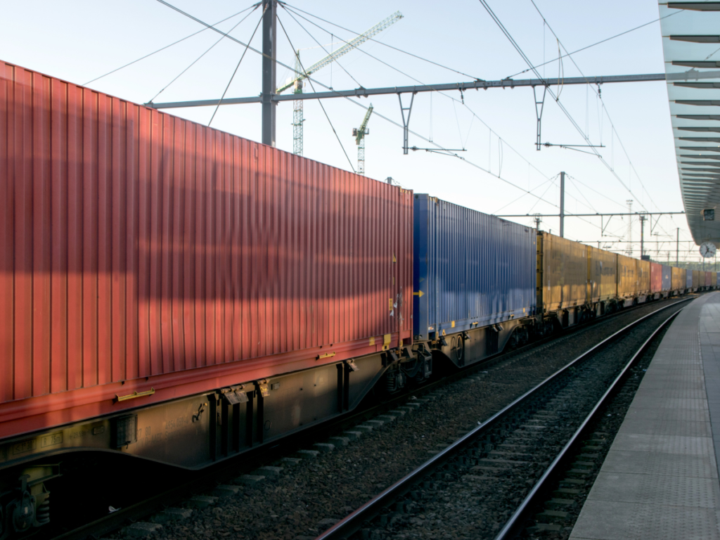 A series of freight carriages waiting at a station