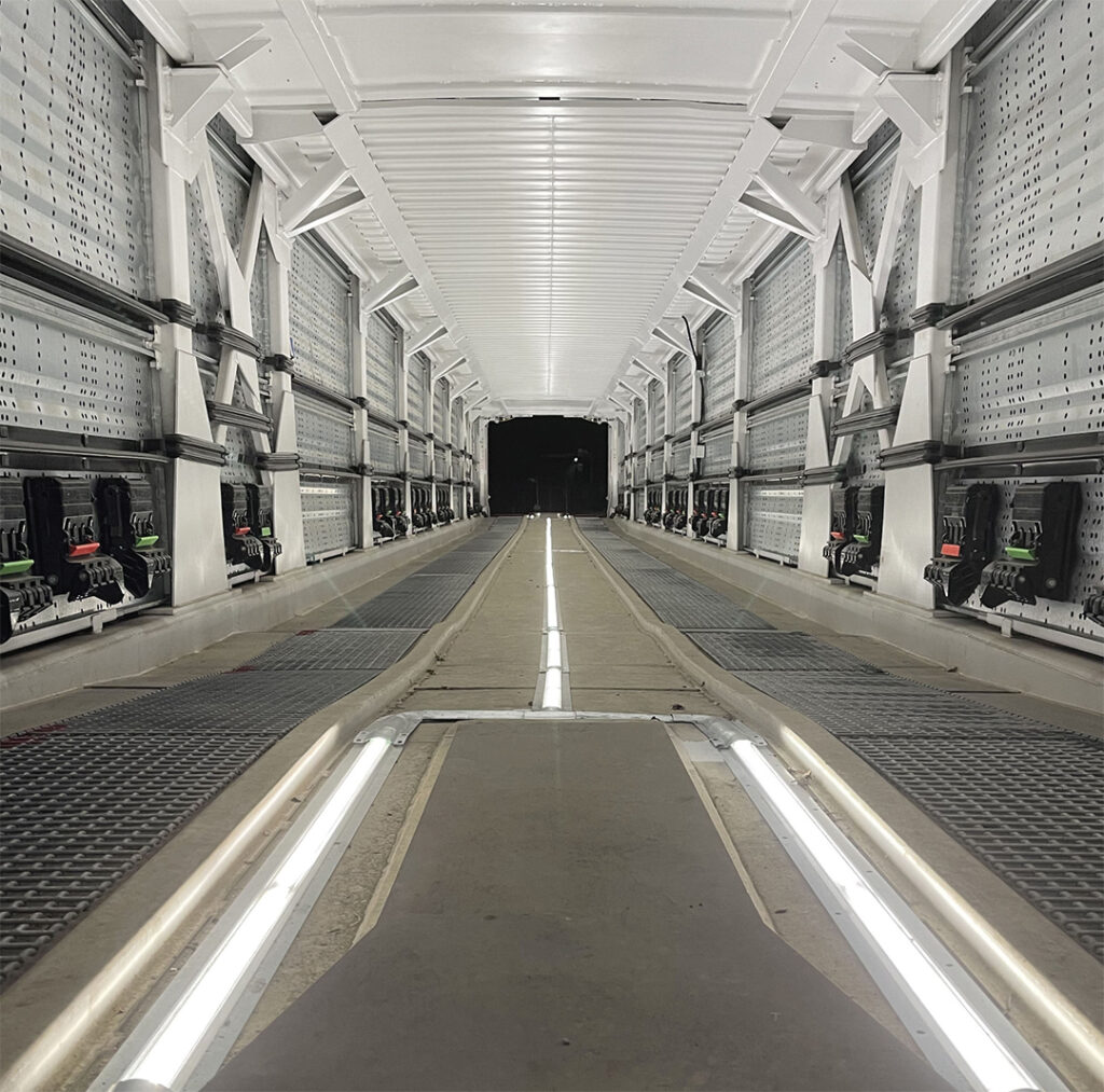 The inside of a railcar with bright white strip LED's in the centre of the floor