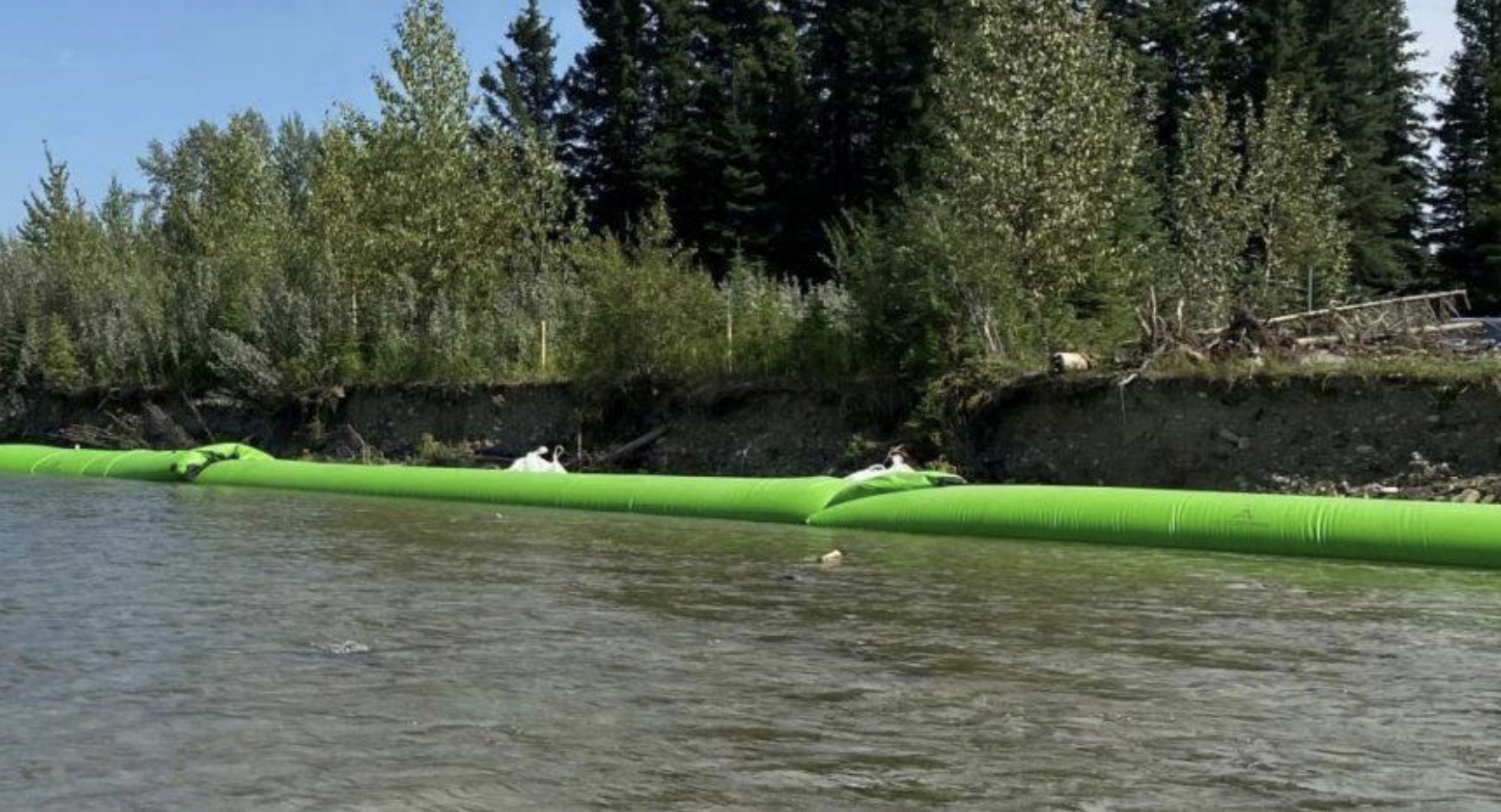 Lime green flood barrier in the water