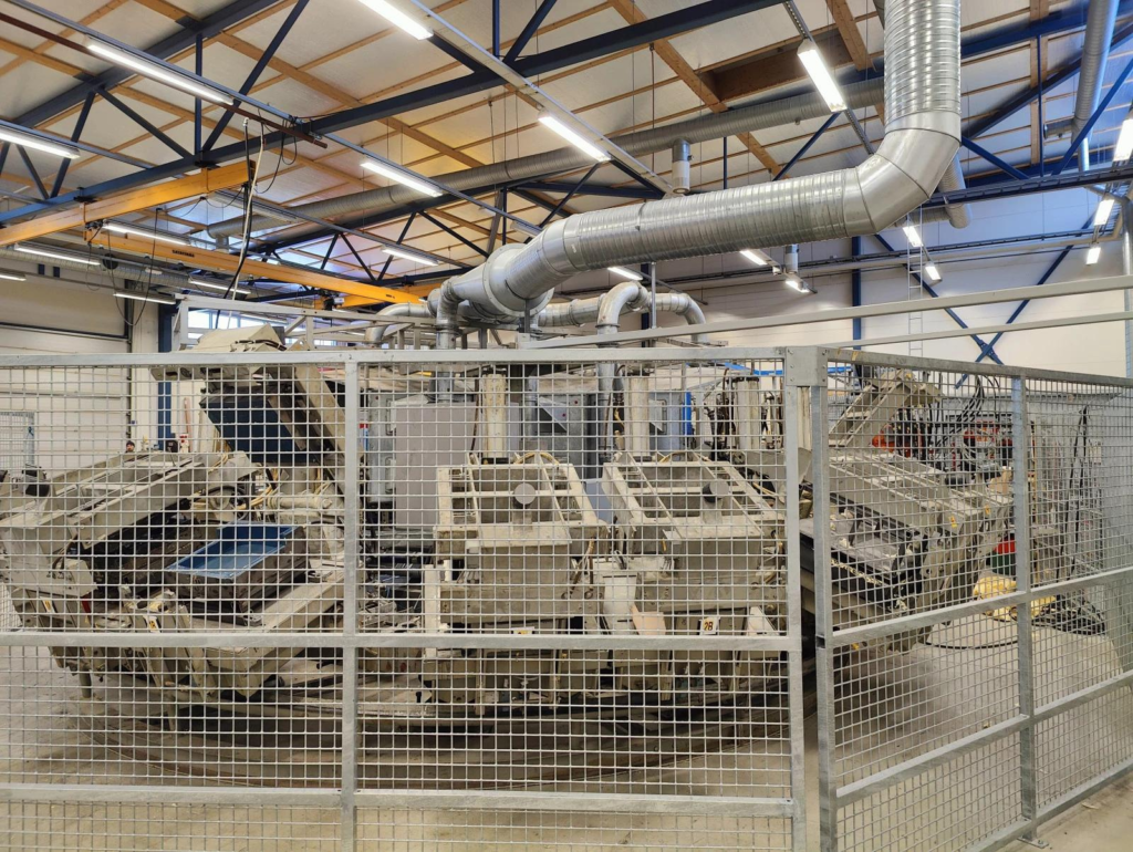 A foam production machine behind a metal fence