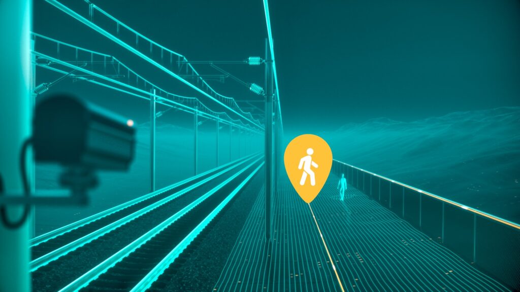 A computer generated image of a person walking beside a railway. Glowing orange fiber optic cables run alongside the track and on the fence. A large warning sign/pin of a person walking is next to the person. A CCTV camera monitors the person from the foreground. 