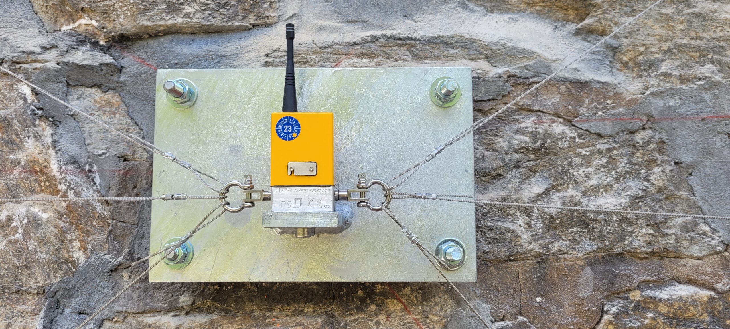 Wall-mounted sensor measuring movement in critical tunnel sections.