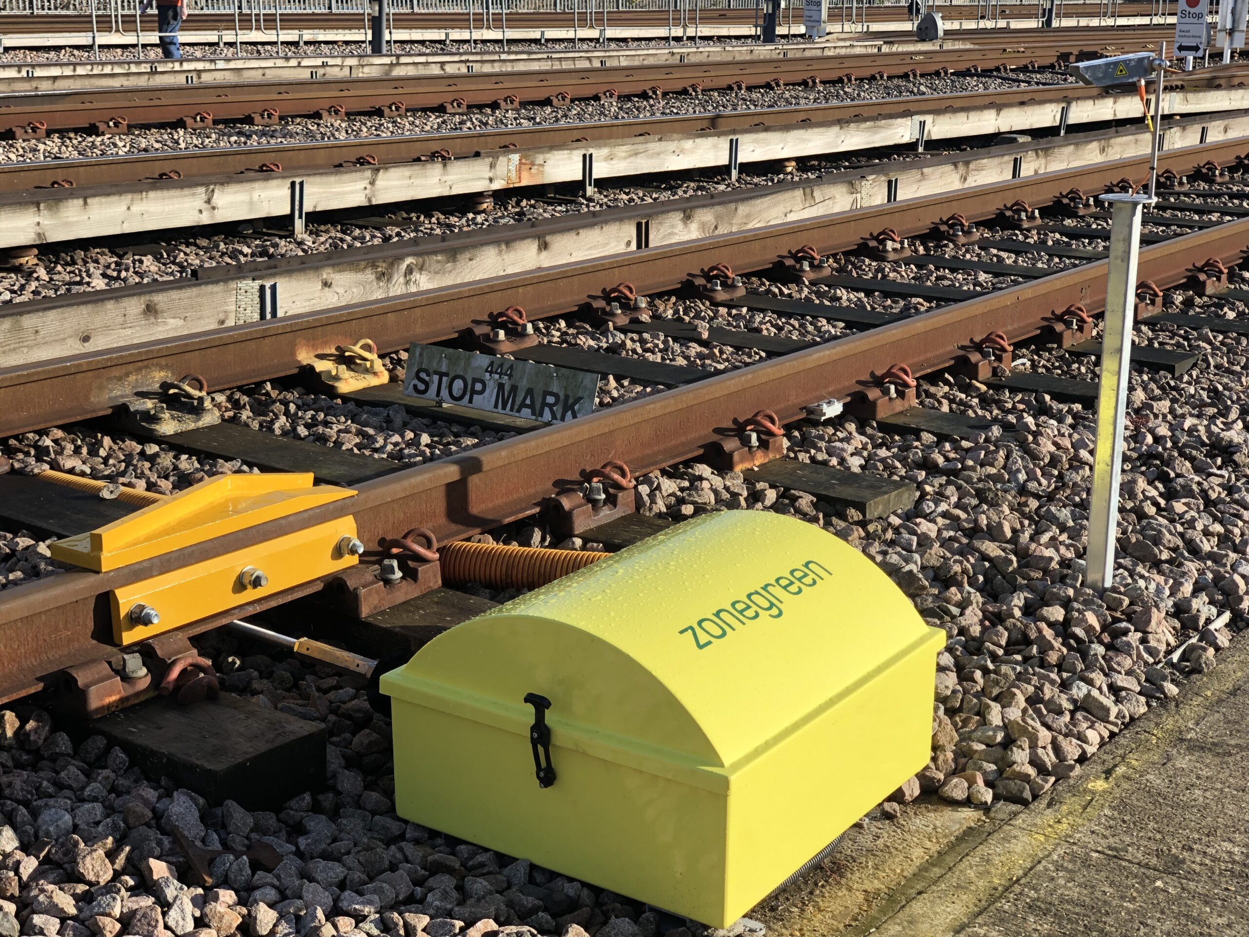 Yellow Zonegreen derailer beside railway track
