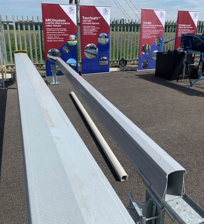Exhibition display of SP Products’ ARCOsystem elevated cable trough and infrastructure solutions under sunny outdoor conditions.