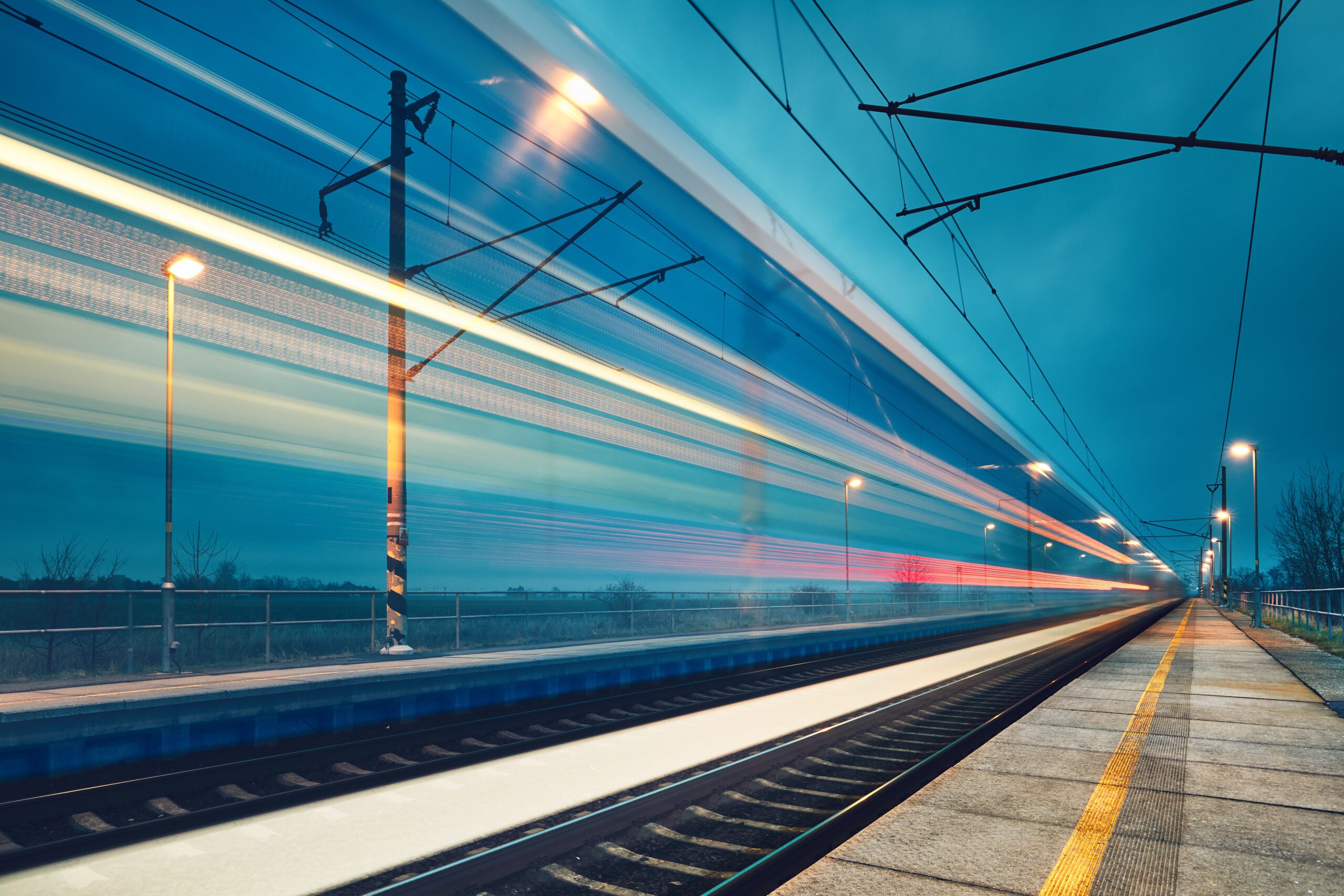 Light trail of the express train in the railway station at the night