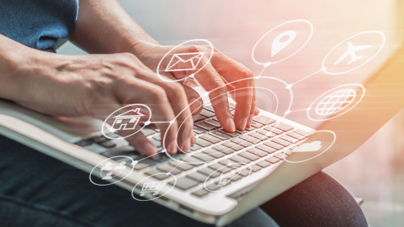 Person typing on a laptop with digital icons representing communication, navigation, and cloud services overlaid, symbolising connectivity and technology integration.