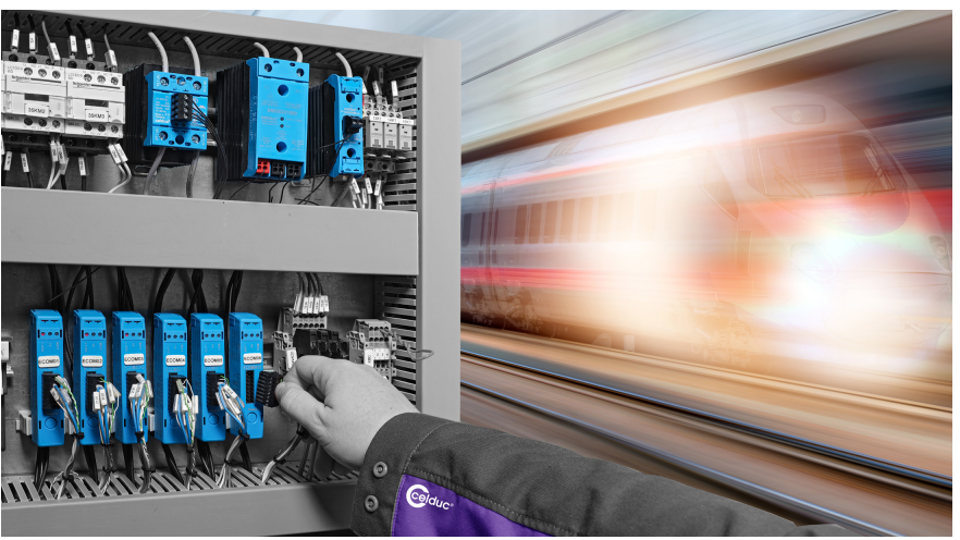 A composite image shows a hand connecting wires in an electrical control panel with blue components on the left, and a blurred, speeding train on a track with a warm glow on the right.