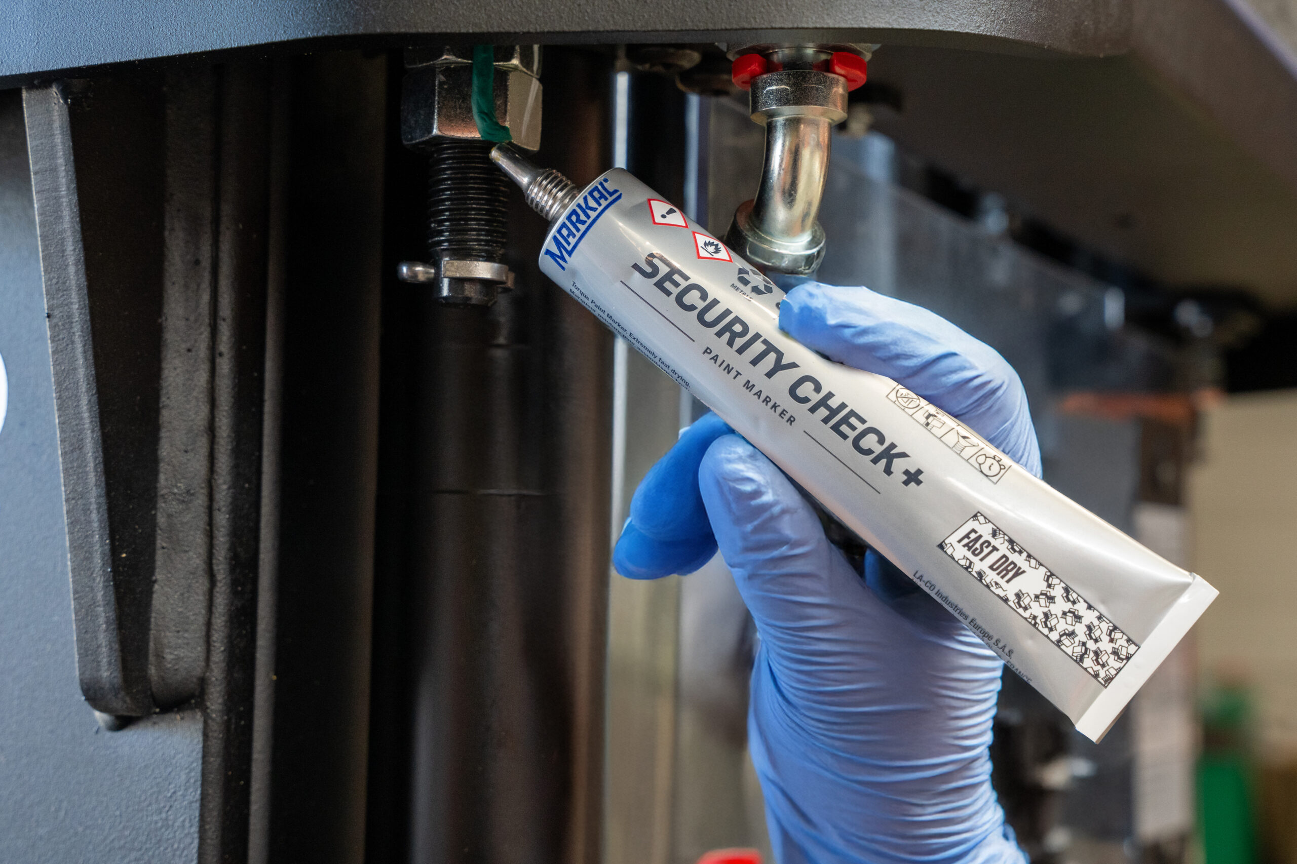 Application of the Markal® SECURITY CHECK+ Fast Dry paint marker on a bolted connection, producing a thick, 3D mark for enhanced visibility