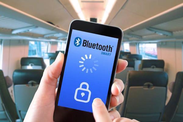 Graphic of a hand holding a smartphone, the phone screen shows a Bluetooth display