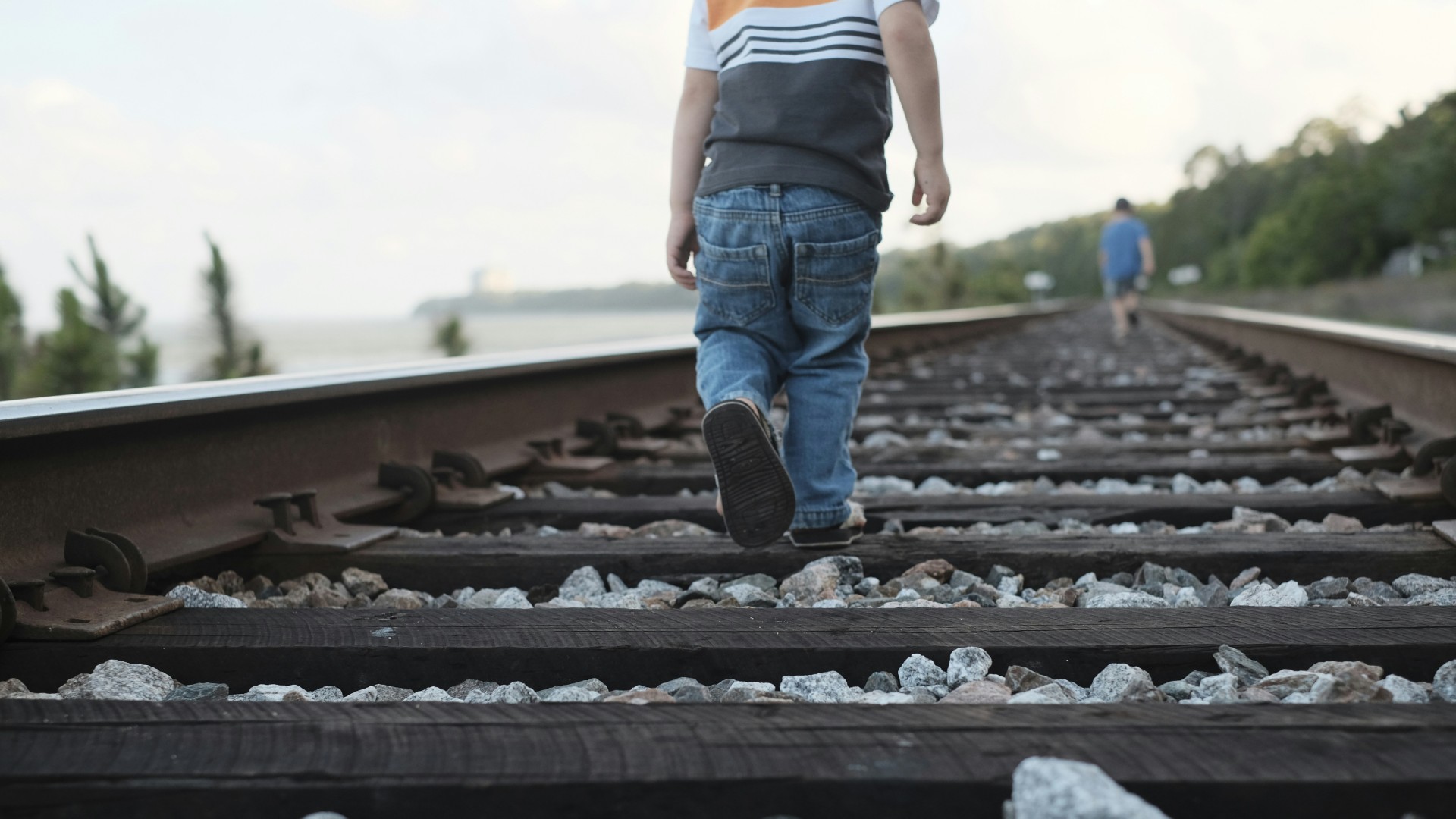 Child walking on railway track