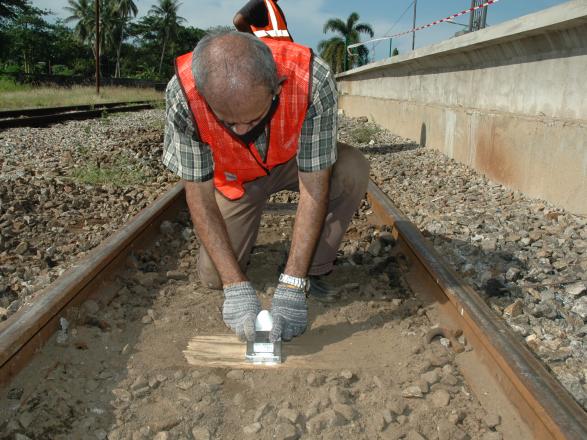 Wireless tilt sensors being installed to trackbed sleepers 
