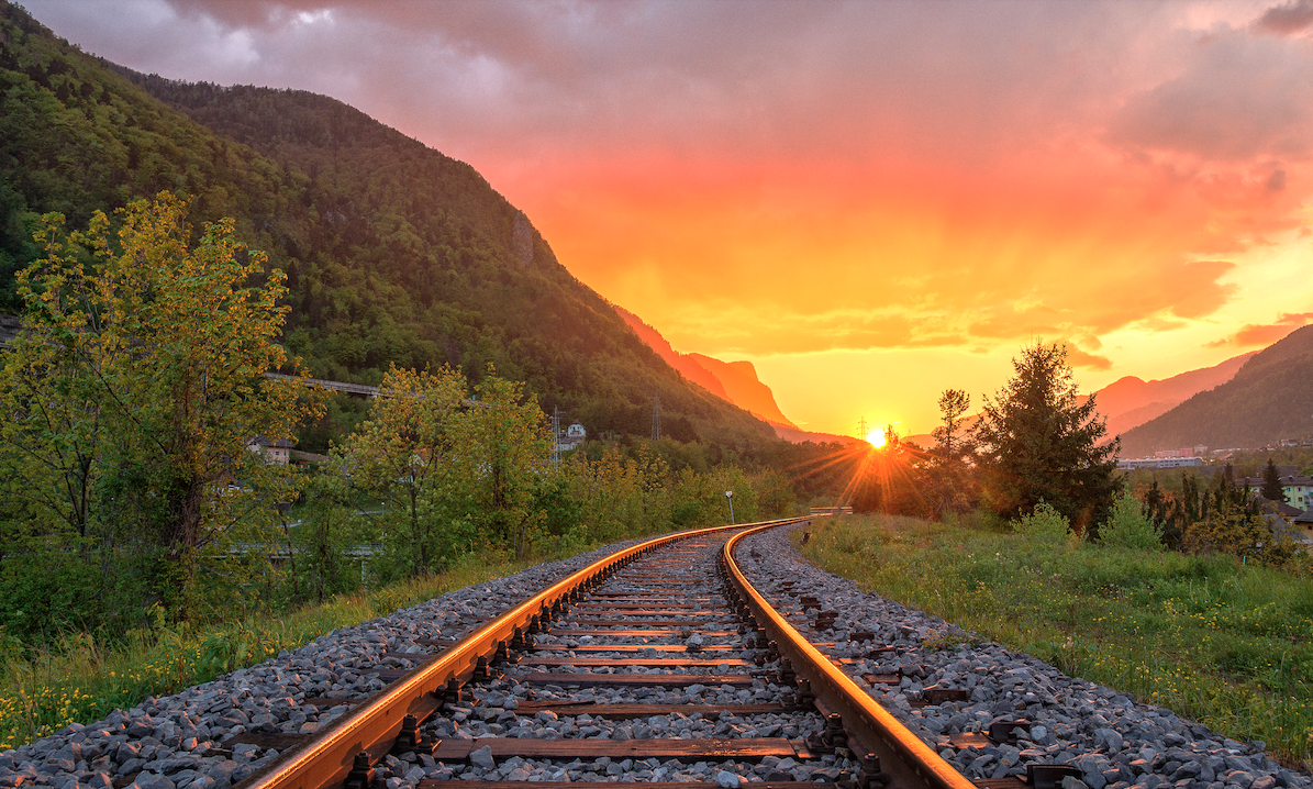 Train tracks through the countryside, vanishing into the distance