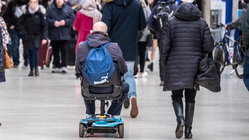 A person travelling on a mobility scooter