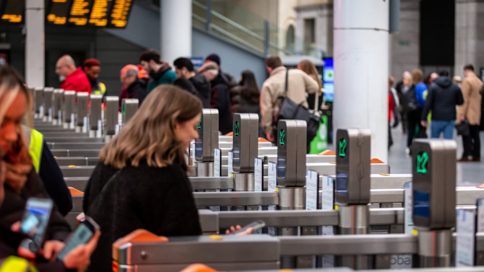 Customers walking through a gateline at Manchester Victoria station 