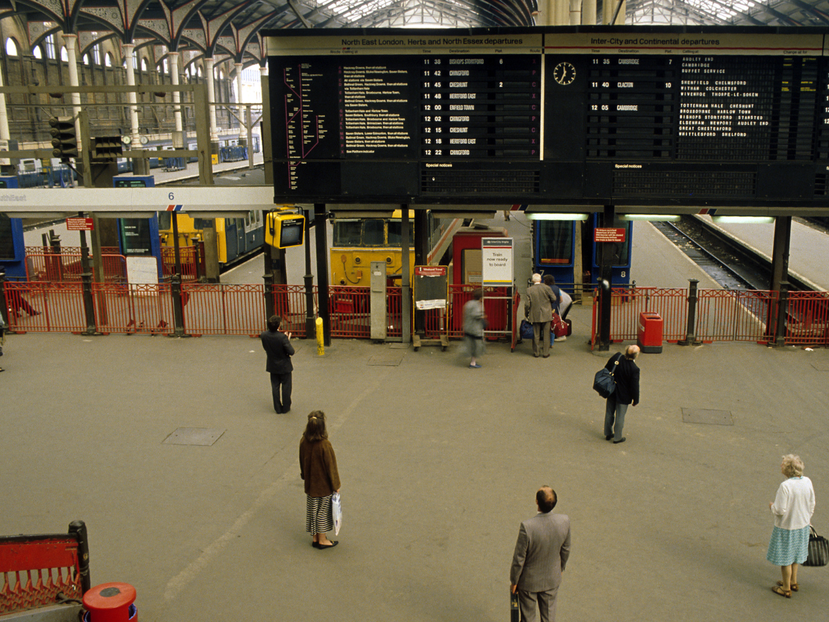 People stood waiting at a station concourse