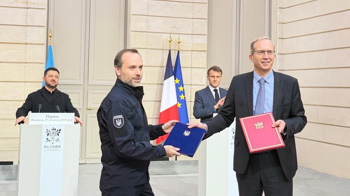 Four men celebrating the receipt of a contract