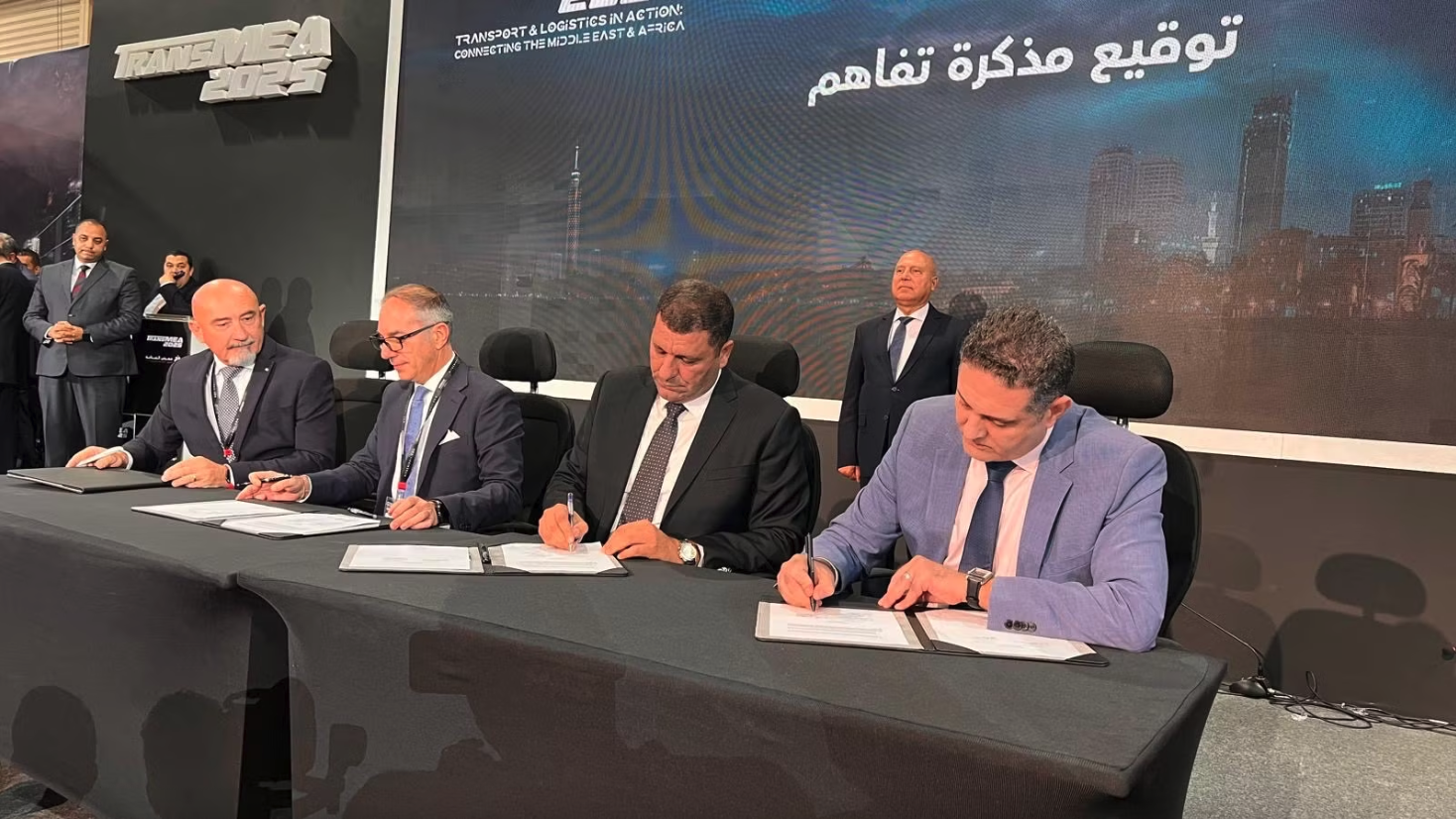 A group of men signing contracts