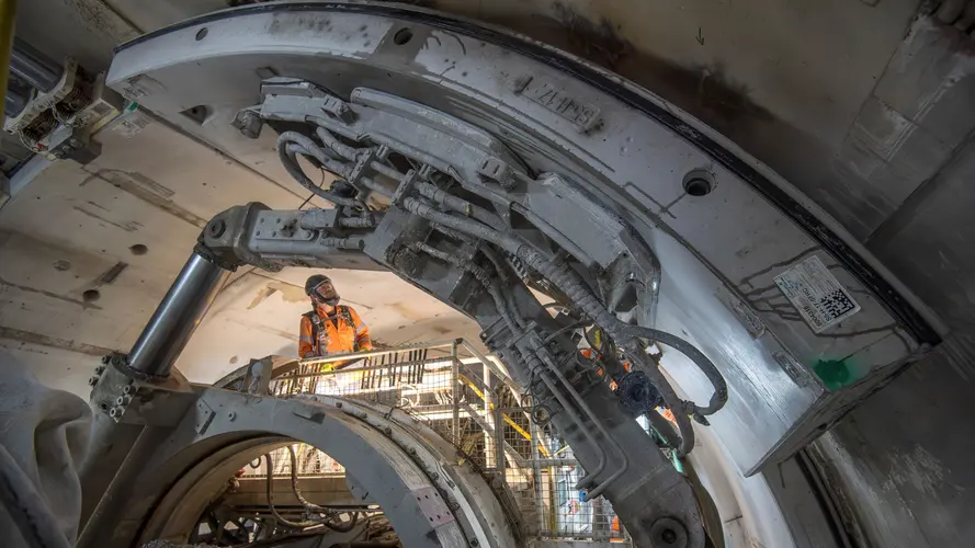 A worker checking a tunnel boring machine