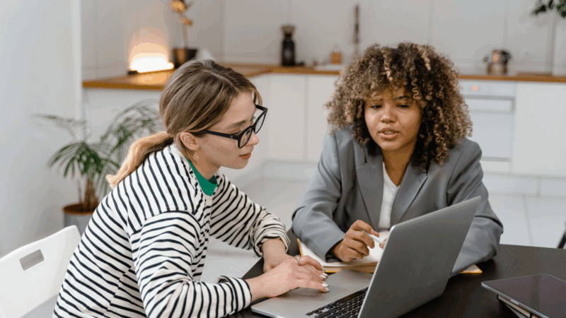 Two people looking at a computer