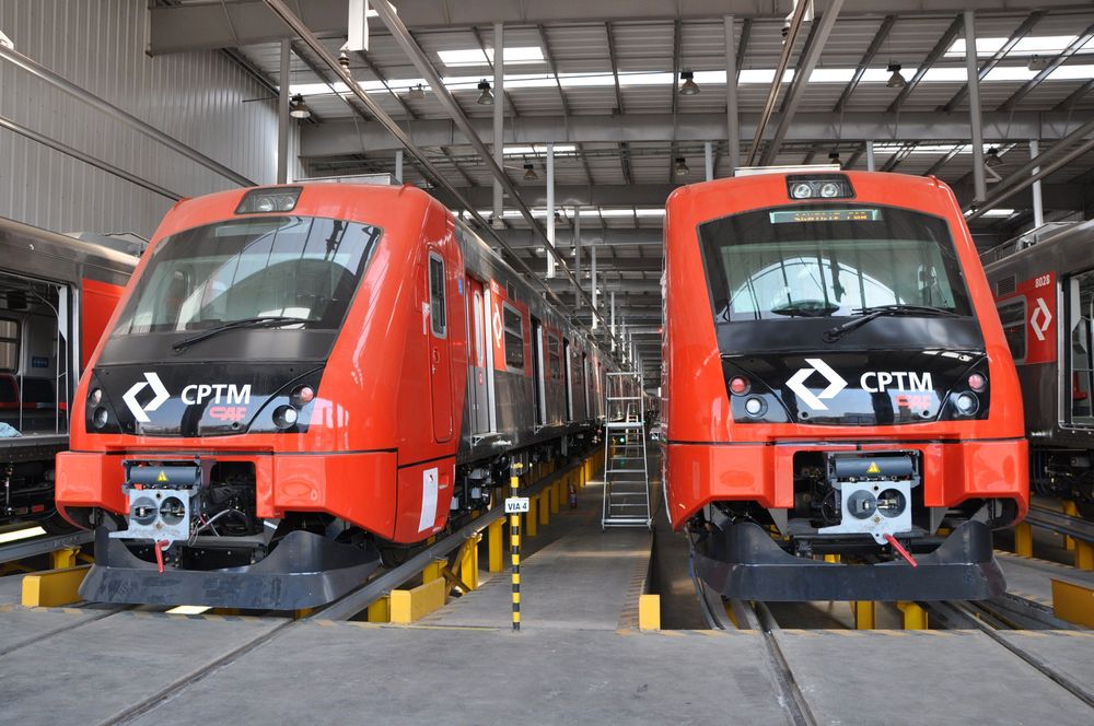 Two red trains in a maintenance facility