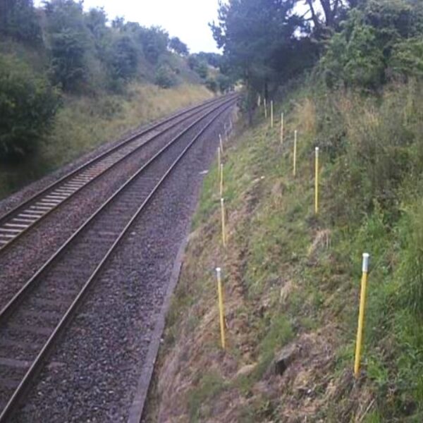 Pole mounted tilt sensors spaced at 2.5m intervals for monitoring slope movement. Photo from Network Rail