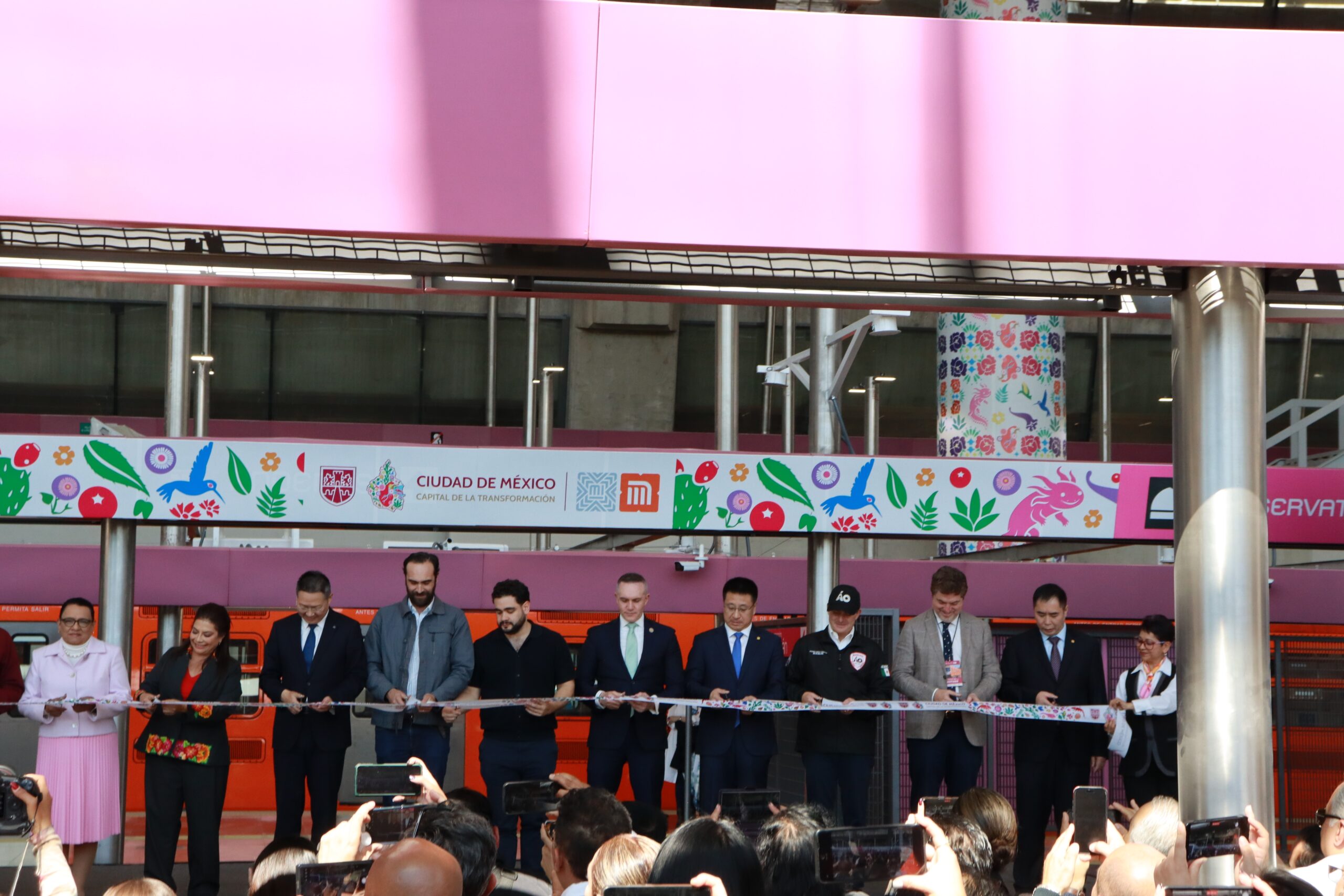 A line of people cutting a a ribbon