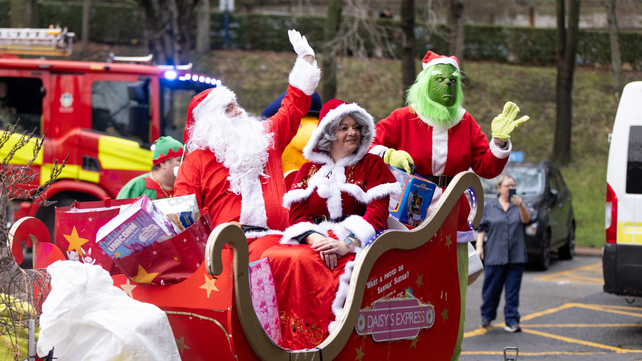 A group of people dressed in festive outfits in a sleigh
