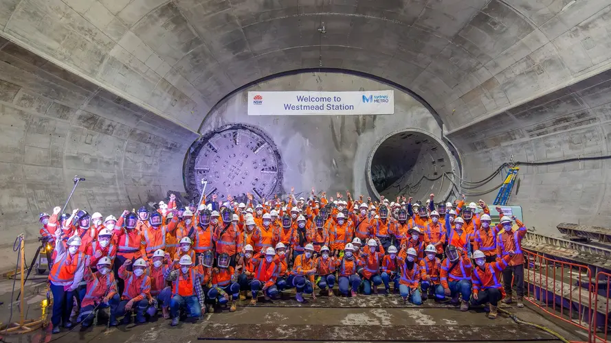 A team celebrating in front of a hole