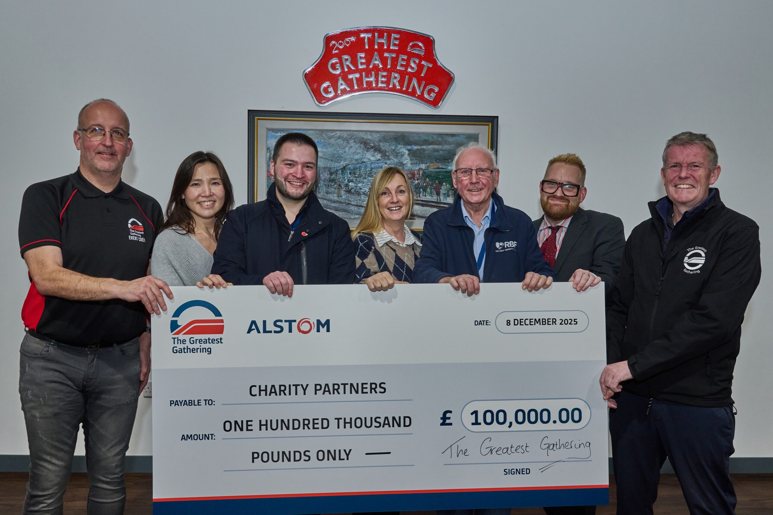 A group of people holding a very big cheque