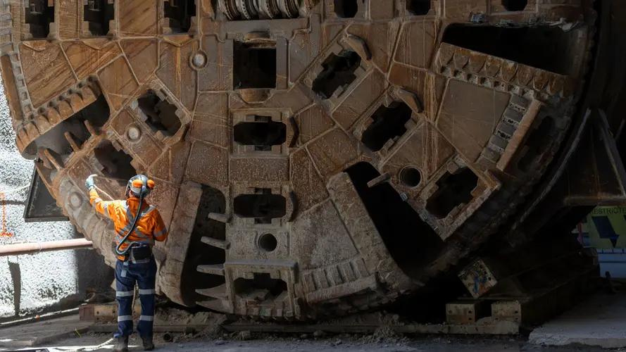 A cutterhead being lifted from the ground