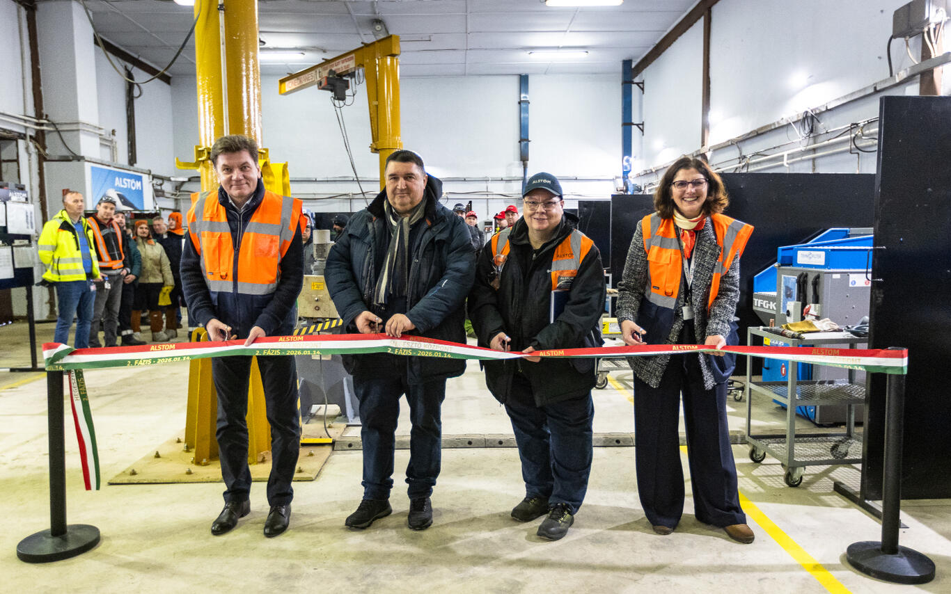 A line of people cutting a ribbon