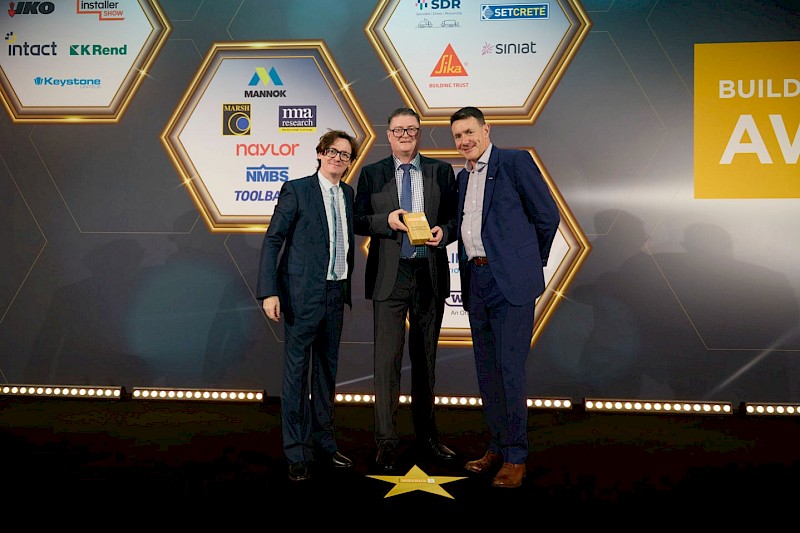 This photo was taken at the Builders Merchants Awards showing the 3 men holding the 'Civils Merchant of the Year’ Award