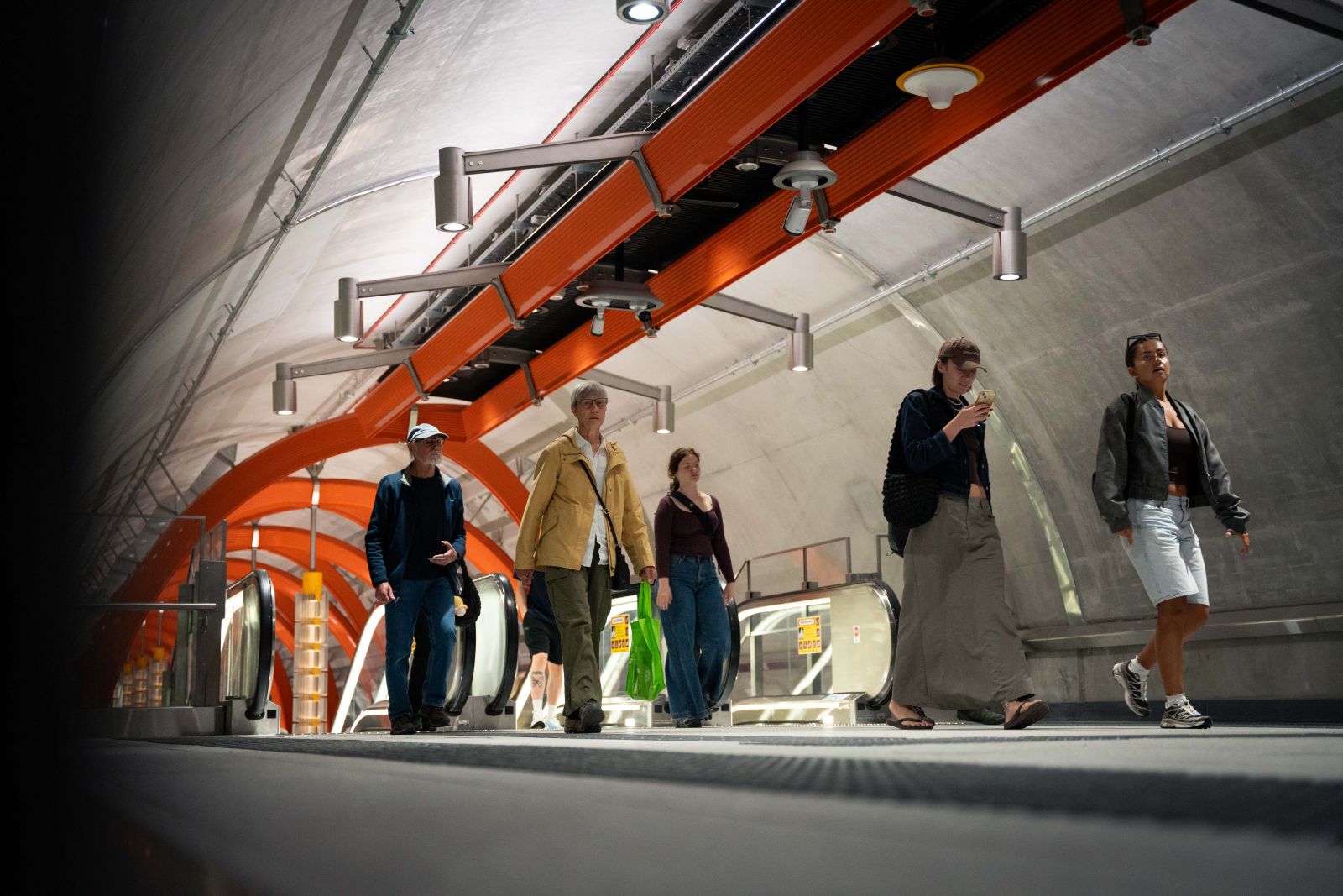Passengers walking through a tunnel