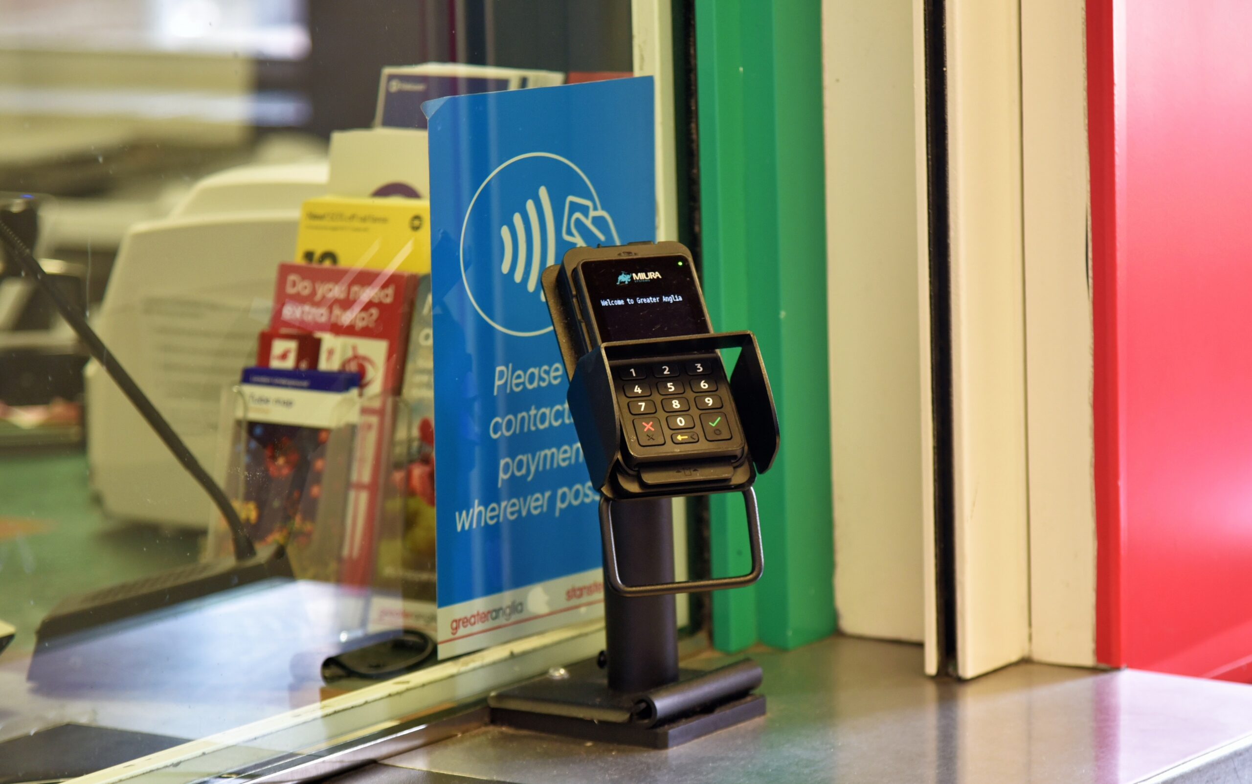 Counter-top Chip and PIN device at a traditional rail ticket office.